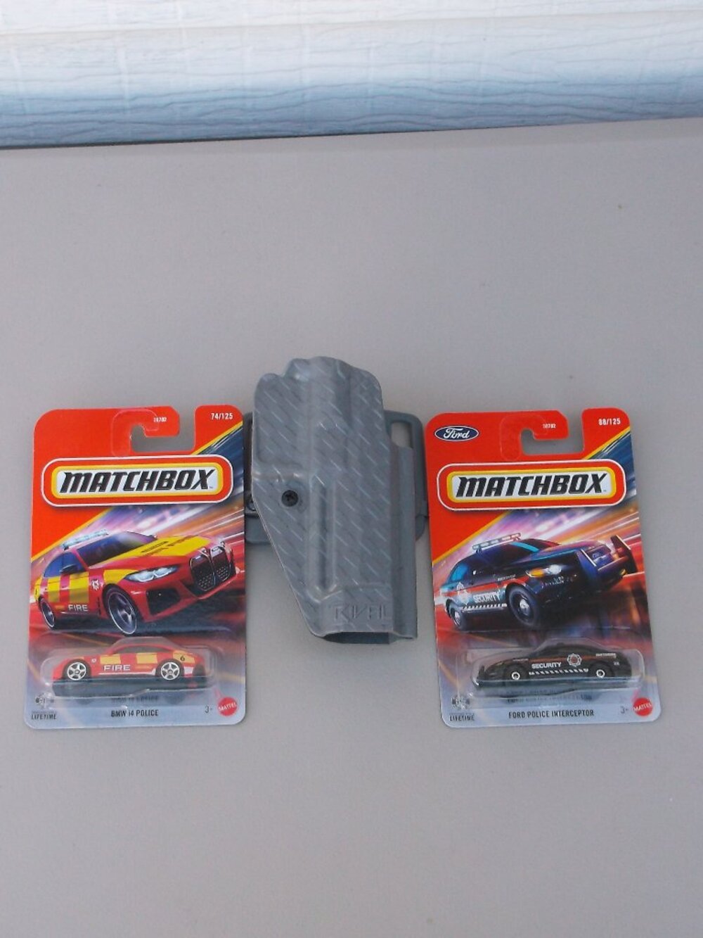 Like New RIVAL Holster + 2 NWT Matchbox Cars (BMW i4 Fire • Ford Police